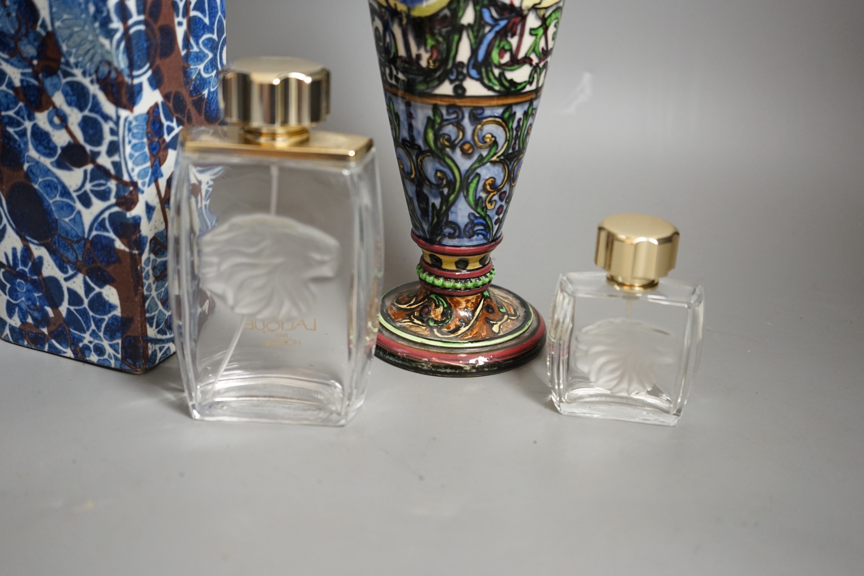 A Royal Copenhagen faience vase and a grotesque style bottle vase and two Lalique pour Homme perfume bottles, faience vase 23cms high